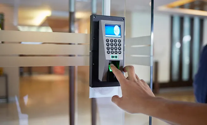 A person using a touch screen to unlock a door, emphasizing colocation security measures.
